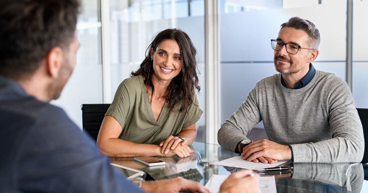 Couple discussing Solo 401(k) options for their LLC with advisor